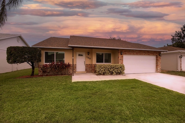 188 Wandering Trl, Jupiter, FL 33458 - view of front facade with concrete driveway, a garage, a front lawn, roof with shingles, and stone siding