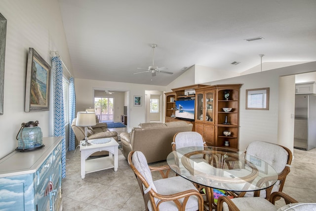 188 Wandering Trl, Jupiter, FL 33458 - dining space with vaulted ceiling, a ceiling fan, and light tile patterned floors