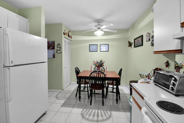 5196 Europa Dr Unit D, Boynton Beach, FL 33437 - dining area featuring ceiling fan, light tile patterned flooring, a textured ceiling, and baseboards