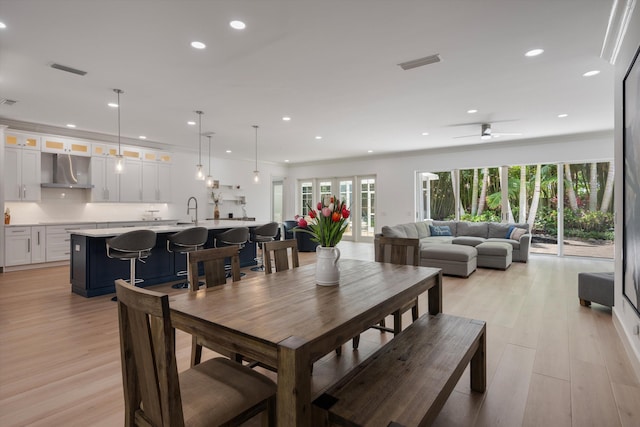 1770 Flagler Manor Cir, West Palm Beach, FL 33411 - dining area featuring light wood finished floors, ceiling fan, recessed lighting, and crown molding