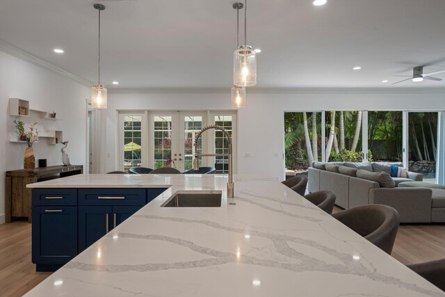 1770 Flagler Manor Cir, West Palm Beach, FL 33411 - kitchen with a sink, open floor plan, ornamental molding, french doors, and plenty of natural light