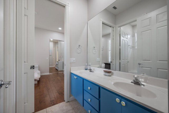 1770 Flagler Manor Cir, West Palm Beach, FL 33411 - ensuite bathroom with double vanity, tile patterned floors, and baseboards