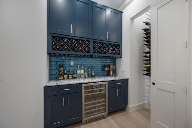 1770 Flagler Manor Cir, West Palm Beach, FL 33411 - indoor dry bar with beverage cooler, light wood-type flooring, backsplash, and baseboards