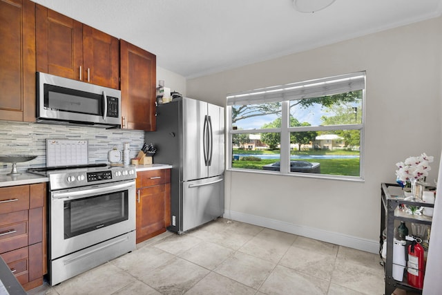 3110 Kingston Ct, West Palm Beach, FL 33409 - kitchen with appliances with stainless steel finishes, decorative backsplash, light countertops, and baseboards