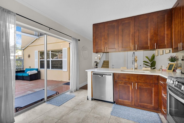 3110 Kingston Ct, West Palm Beach, FL 33409 - kitchen with stainless steel appliances, a sink, light countertops, and a peninsula