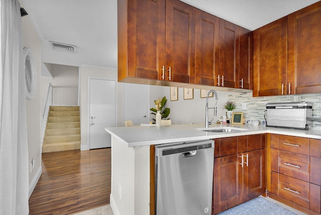 3110 Kingston Ct, West Palm Beach, FL 33409 - kitchen with dishwasher, a sink, light countertops, decorative backsplash, and wood finished floors