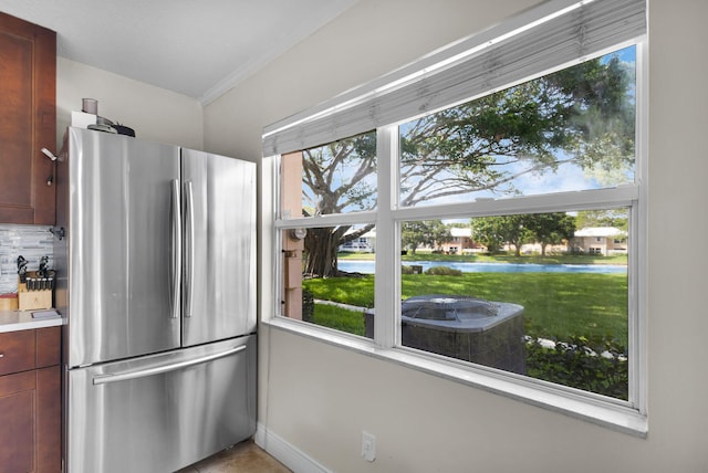3110 Kingston Ct, West Palm Beach, FL 33409 - kitchen with freestanding refrigerator, a water view, ornamental molding, baseboards, and light countertops