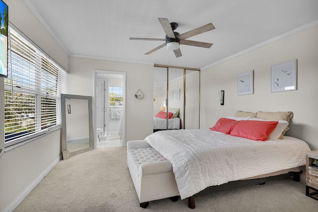 3110 Kingston Ct, West Palm Beach, FL 33409 - carpeted bedroom featuring ornamental molding, ensuite bathroom, baseboards, a ceiling fan, and a closet