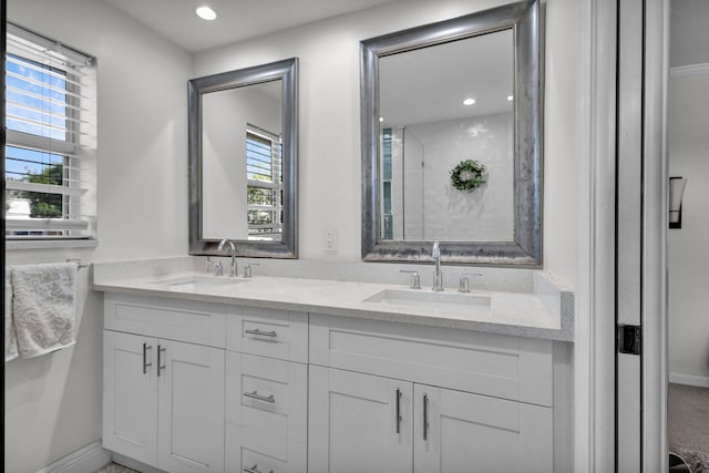 3110 Kingston Ct, West Palm Beach, FL 33409 - bathroom with double vanity, baseboards, and recessed lighting