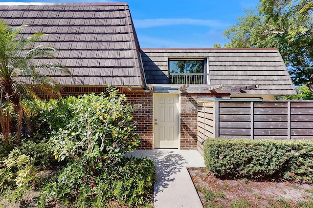615 6th Ter, Palm Beach Gardens, FL 33418 - property entrance with brick siding and mansard roof