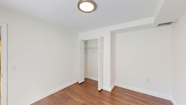 615 6th Ter, Palm Beach Gardens, FL 33418 - unfurnished bedroom with dark wood-style flooring, baseboards, and a closet