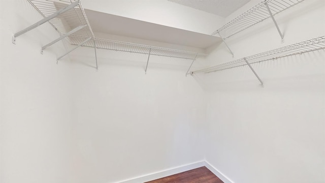 615 6th Ter, Palm Beach Gardens, FL 33418 - spacious closet featuring dark wood-style floors