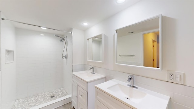 615 6th Ter, Palm Beach Gardens, FL 33418 - bathroom with tiled shower, two vanities, and recessed lighting