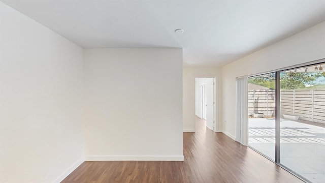 615 6th Ter, Palm Beach Gardens, FL 33418 - empty room featuring baseboards and wood finished floors