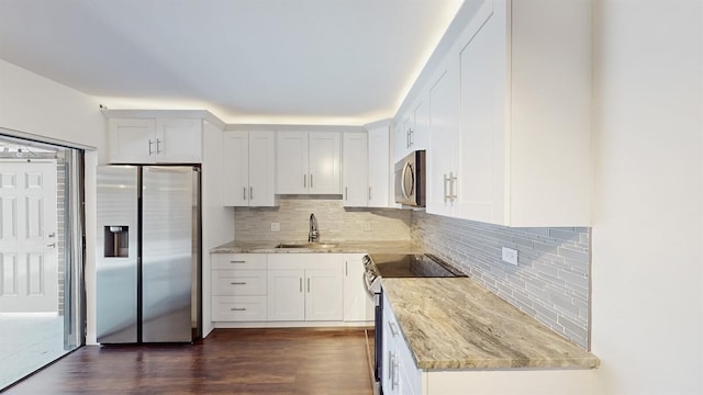 615 6th Ter, Palm Beach Gardens, FL 33418 - kitchen featuring stainless steel appliances, a sink, light stone counters, backsplash, and dark wood-style floors