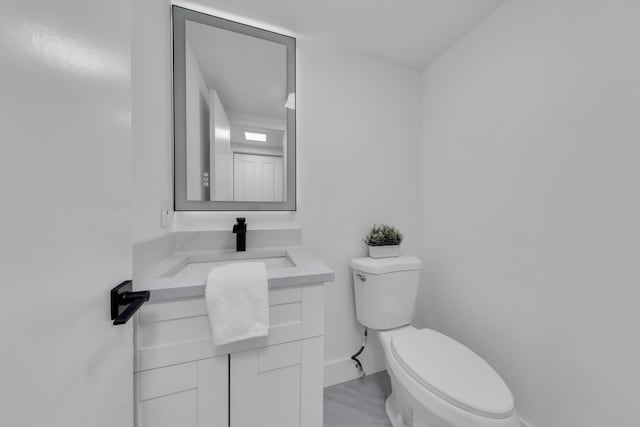 76 Mansfield B 76, Boca Raton, FL 33434 - bathroom with toilet, vanity, marble look tile flooring, and baseboards
