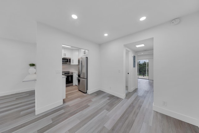 76 Mansfield B 76, Boca Raton, FL 33434 - kitchen with stainless steel appliances, white cabinets, recessed lighting, light wood finished floors, and light countertops