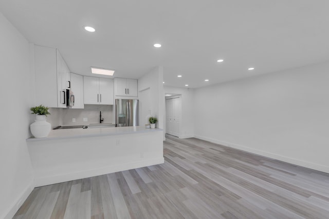 76 Mansfield B 76, Boca Raton, FL 33434 - kitchen featuring stainless steel appliances, a sink, light countertops, a peninsula, and baseboards