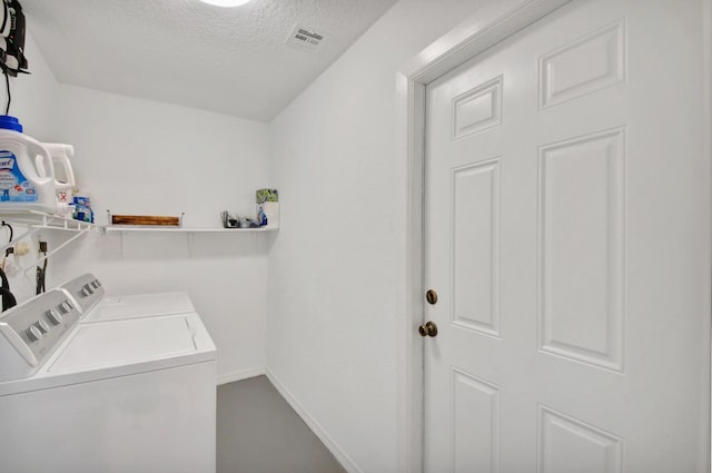5472 Courtney Cir, Boynton Beach, FL 33472 - laundry room featuring washer and clothes dryer, a textured ceiling, and baseboards