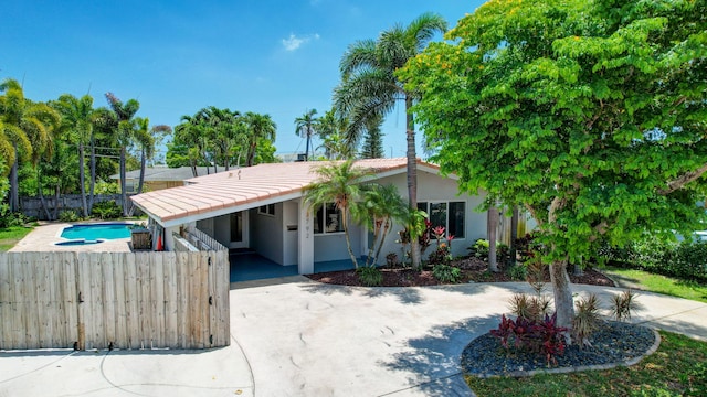 3792 NE 19th Ave, Oakland Park, FL 33308 - view of front facade featuring concrete driveway, stucco siding, a tile roof, and an attached carport