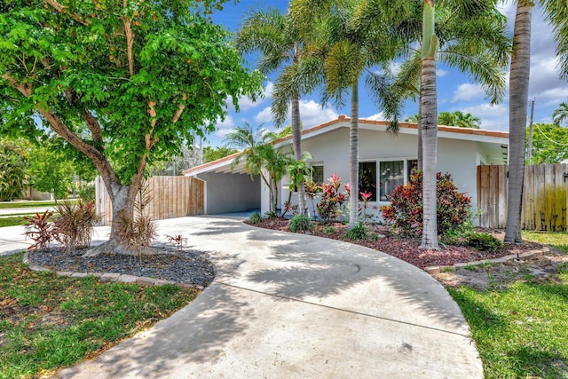 3792 NE 19th Ave, Oakland Park, FL 33308 - view of front of home with stucco siding, driveway, and a carport