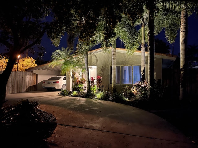 3792 NE 19th Ave, Oakland Park, FL 33308 - view of front facade featuring an attached carport, stucco siding, and concrete driveway