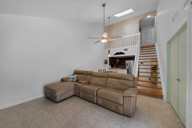 4099 Palm Bay Cir Unit A, West Palm Beach, FL 33406 - living room with ceiling fan, stairs, arched walkways, a skylight, and baseboards