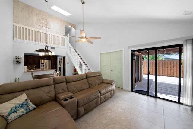4099 Palm Bay Cir Unit A, West Palm Beach, FL 33406 - living area with high vaulted ceiling, ceiling fan, light tile patterned flooring, stairway, and a skylight