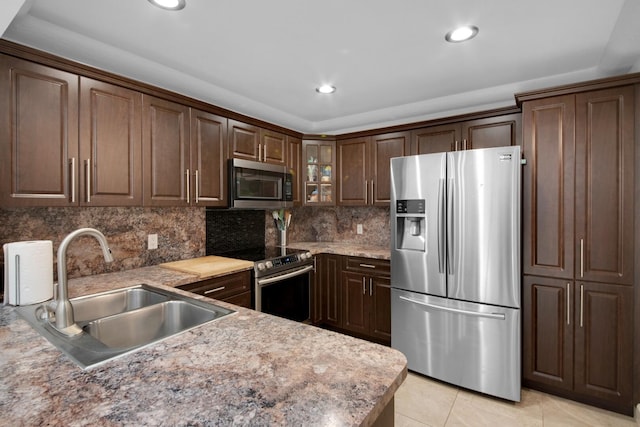 4099 Palm Bay Cir Unit A, West Palm Beach, FL 33406 - kitchen featuring appliances with stainless steel finishes, a sink, decorative backsplash, recessed lighting, and glass insert cabinets