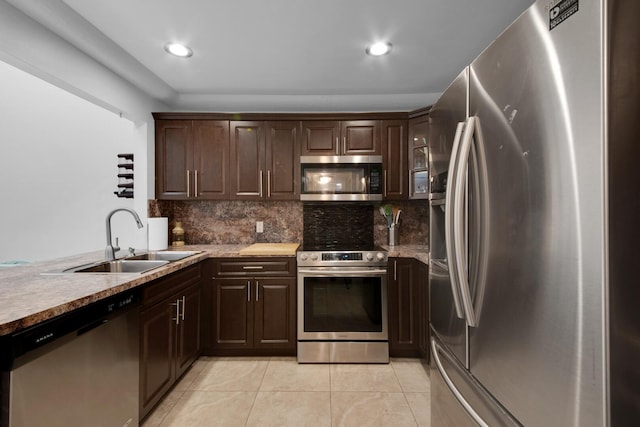 4099 Palm Bay Cir Unit A, West Palm Beach, FL 33406 - kitchen featuring appliances with stainless steel finishes, a sink, light tile patterned floors, dark brown cabinetry, and recessed lighting