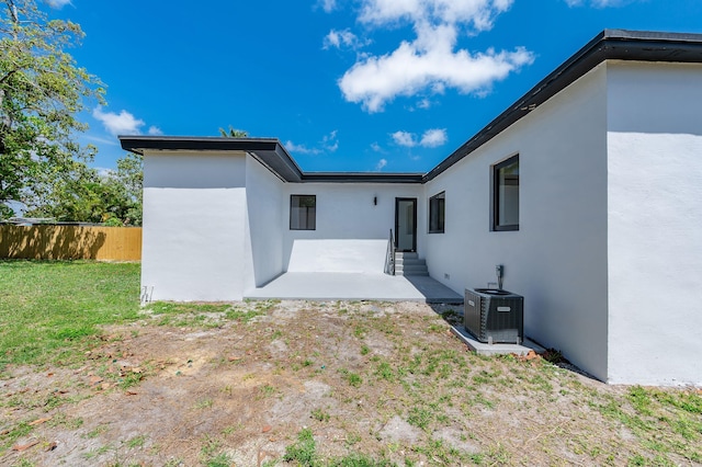 200 SW 48th Ave, Miami, FL 33134 - back of property with cooling unit, stucco siding, entry steps, and a patio area