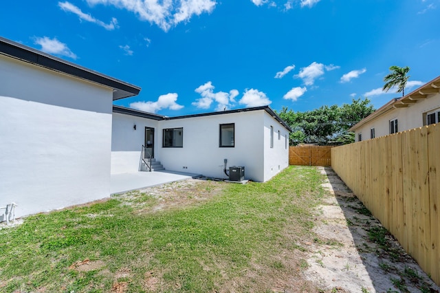 200 SW 48th Ave, Miami, FL 33134 - back of house featuring stucco siding, central air condition unit, and a patio area