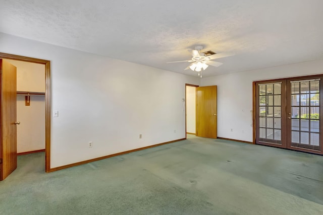 102 SE Crosspoint Dr, Port Saint Lucie, FL 34983 - unfurnished room with baseboards, carpet floors, french doors, a textured ceiling, and a ceiling fan