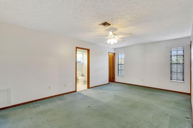 102 SE Crosspoint Dr, Port Saint Lucie, FL 34983 - carpeted empty room with a ceiling fan, baseboards, and a textured ceiling