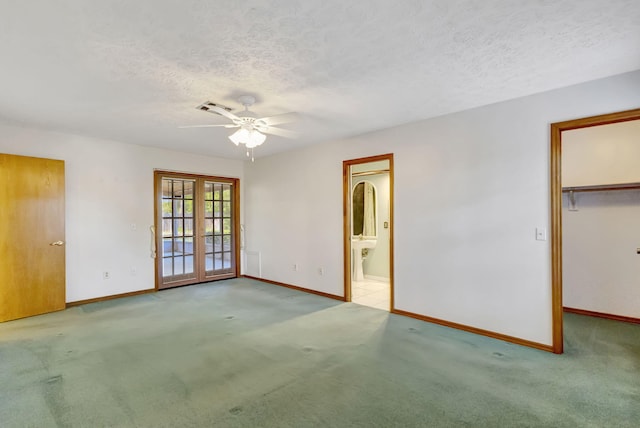 102 SE Crosspoint Dr, Port Saint Lucie, FL 34983 - carpeted spare room with french doors, a textured ceiling, baseboards, and ceiling fan