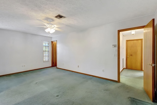 102 SE Crosspoint Dr, Port Saint Lucie, FL 34983 - unfurnished room featuring carpet floors, baseboards, ceiling fan, and a textured ceiling