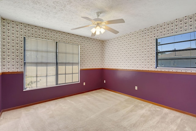 102 SE Crosspoint Dr, Port Saint Lucie, FL 34983 - carpeted empty room with wallpapered walls, ceiling fan, baseboards, and a textured ceiling
