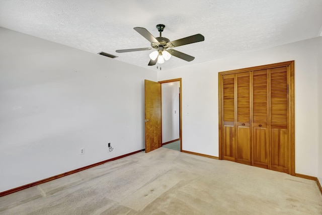 102 SE Crosspoint Dr, Port Saint Lucie, FL 34983 - unfurnished bedroom with baseboards, a closet, carpet, a textured ceiling, and ceiling fan