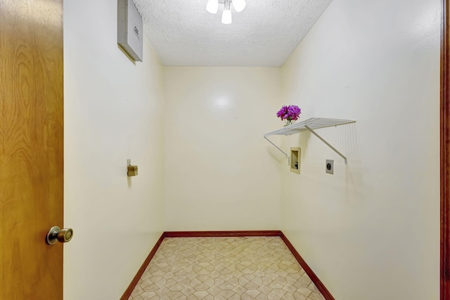 102 SE Crosspoint Dr, Port Saint Lucie, FL 34983 - laundry area with electric dryer hookup, baseboards, washer hookup, a textured ceiling, and tile patterned floors