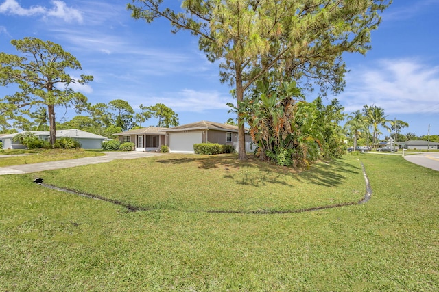 102 SE Crosspoint Dr, Port Saint Lucie, FL 34983 - view of front facade featuring concrete driveway, a garage, a front lawn, and stucco siding