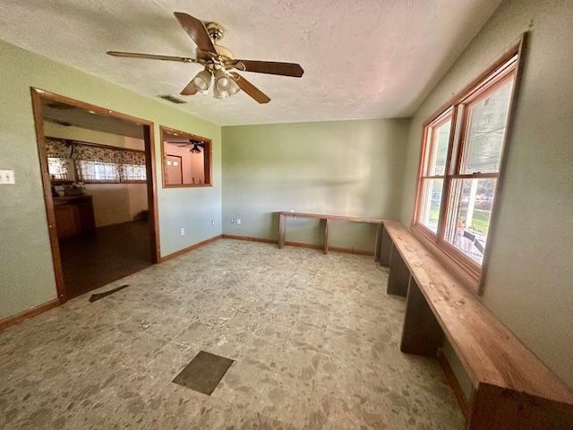 15255 NW 260th St, Okeechobee, FL 34972 - spare room with ceiling fan, a textured ceiling, and baseboards