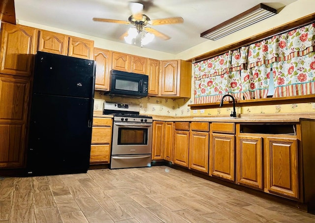 15255 NW 260th St, Okeechobee, FL 34972 - kitchen featuring black appliances, a sink, light countertops, and a ceiling fan