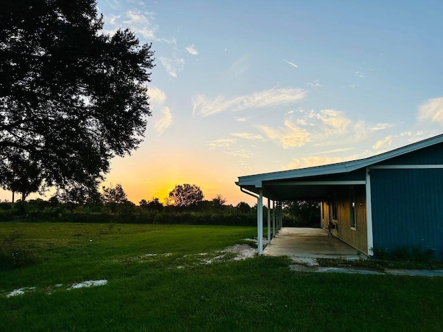 15255 NW 260th St, Okeechobee, FL 34972 - yard at dusk with a yard and an attached carport