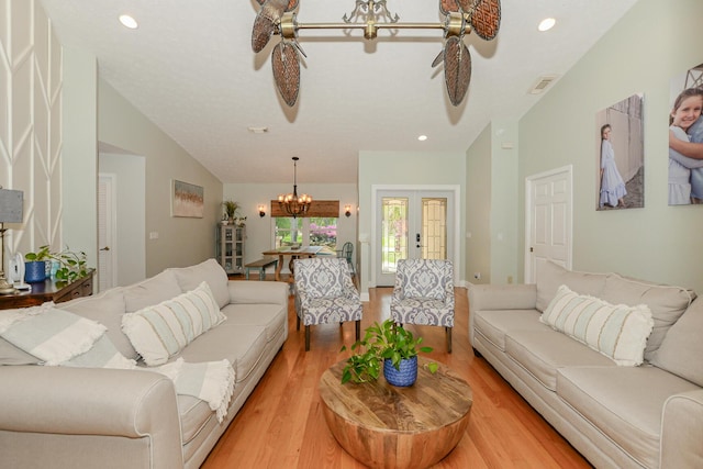 2610 SE Erickson Dr, Port Saint Lucie, FL 34984 - living room with ceiling fan, a chandelier, light wood finished floors, recessed lighting, and vaulted ceiling