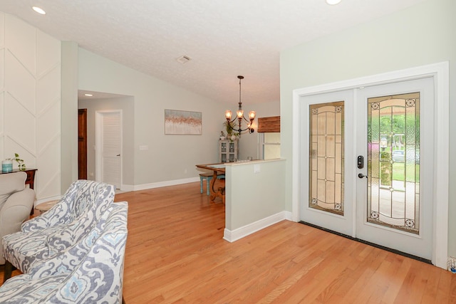 2610 SE Erickson Dr, Port Saint Lucie, FL 34984 - foyer featuring light wood-style floors, lofted ceiling, a chandelier, baseboards, and recessed lighting