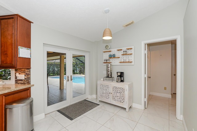 2610 SE Erickson Dr, Port Saint Lucie, FL 34984 - doorway with french doors, baseboards, and light marble finish flooring