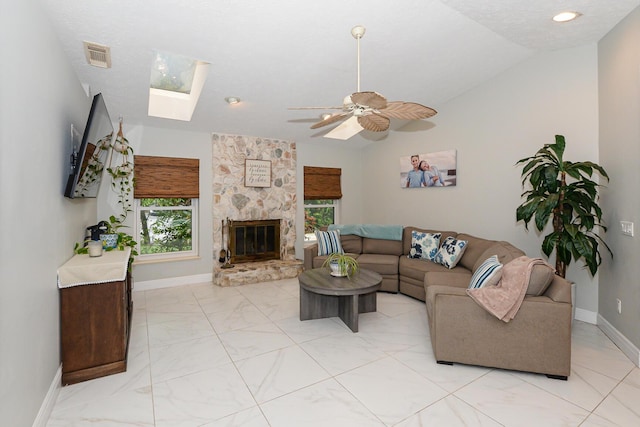 2610 SE Erickson Dr, Port Saint Lucie, FL 34984 - living room with a skylight, healthy amount of natural light, vaulted ceiling, baseboards, and light marble finish flooring