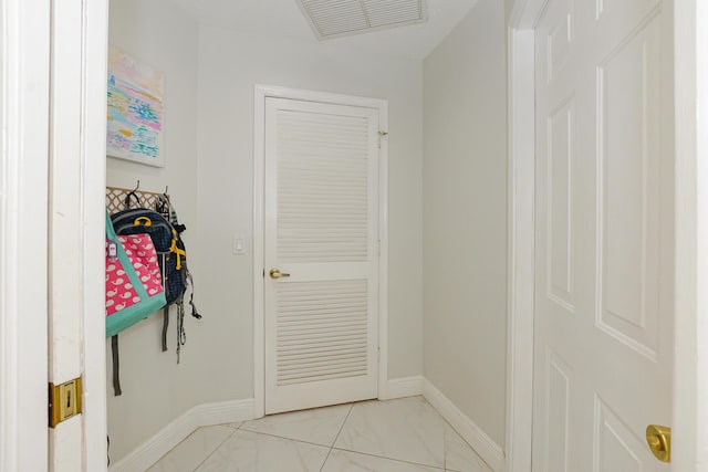 2610 SE Erickson Dr, Port Saint Lucie, FL 34984 - mudroom with baseboards and light marble finish flooring