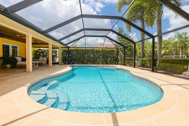 2610 SE Erickson Dr, Port Saint Lucie, FL 34984 - outdoor pool with outdoor lounge area, a patio, and glass enclosure