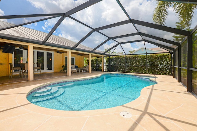 2610 SE Erickson Dr, Port Saint Lucie, FL 34984 - view of pool featuring a ceiling fan, a patio, french doors, a pool with connected hot tub, and a lanai